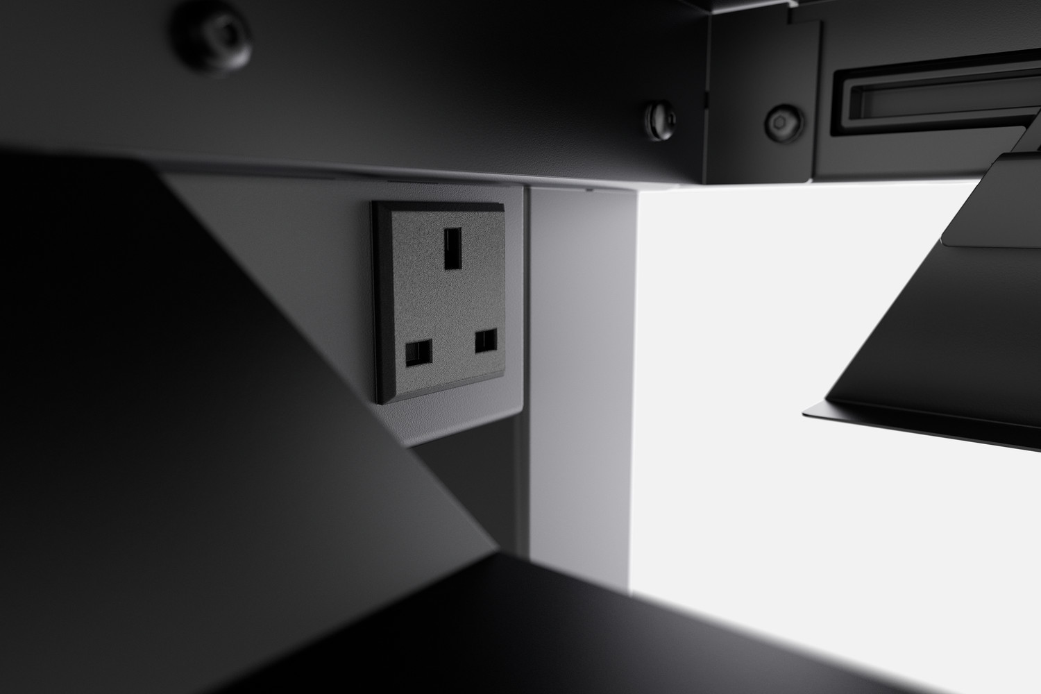 Under desk view showing power cord and a monitor arm attachment with black finish