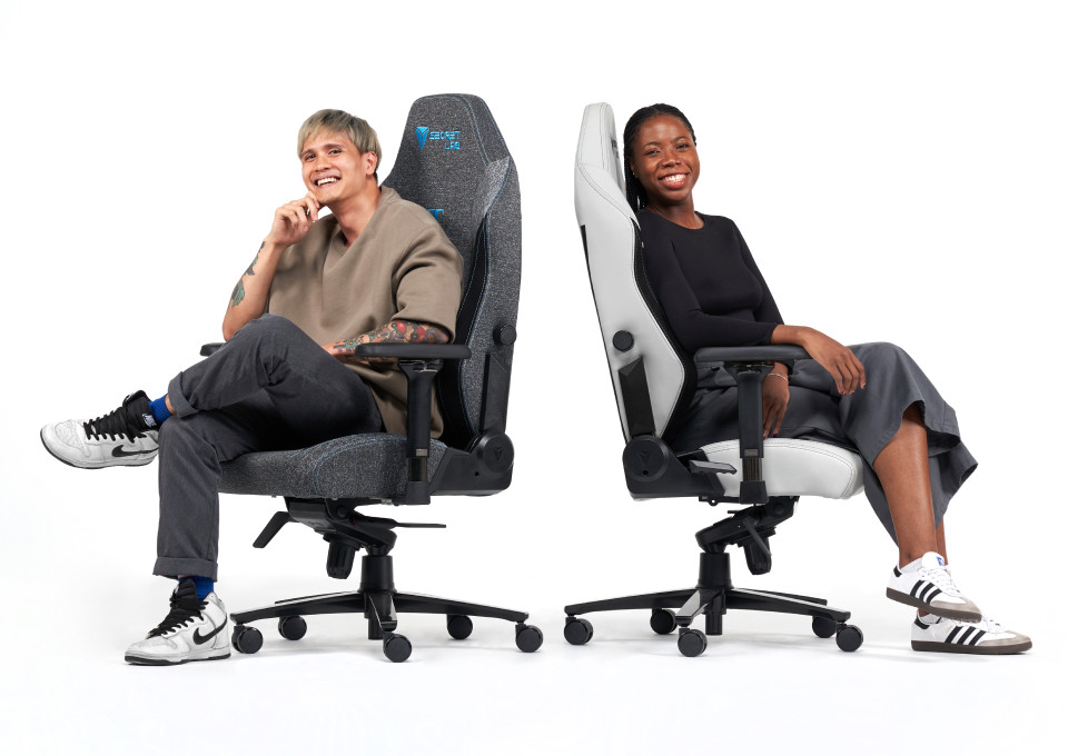 A man and woman smiling on the Secretlab TITAN Evo ergonomic chair.