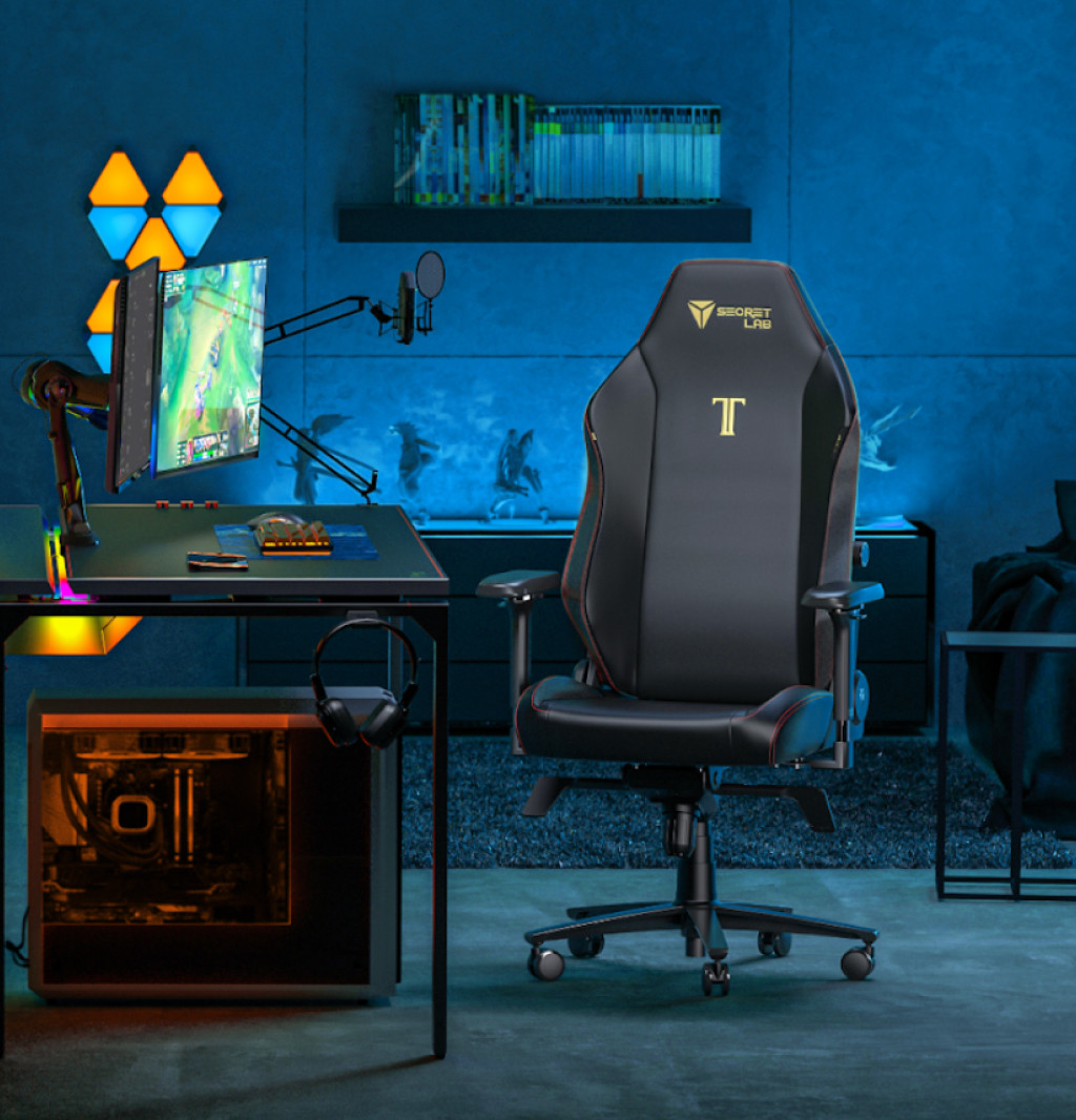 A black Stealth Secretlab TITAN Evo gaming chair and set up in a dark, gaming environment
