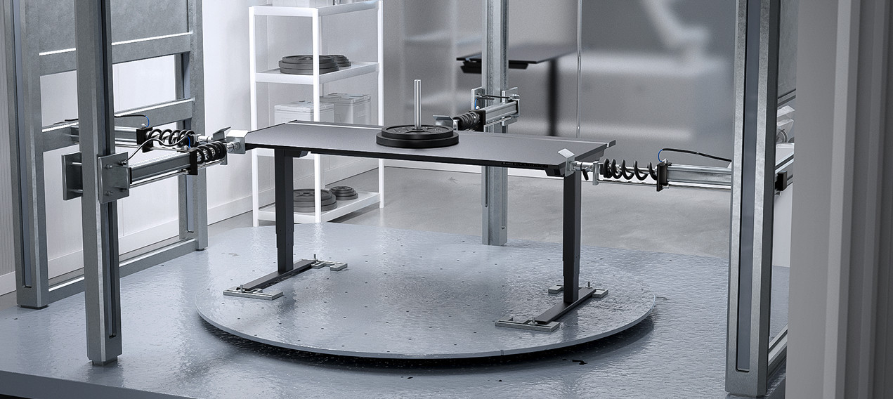 An R&D image of the Secretlab MAGNUS Pro standing desk undergoing load compression tests