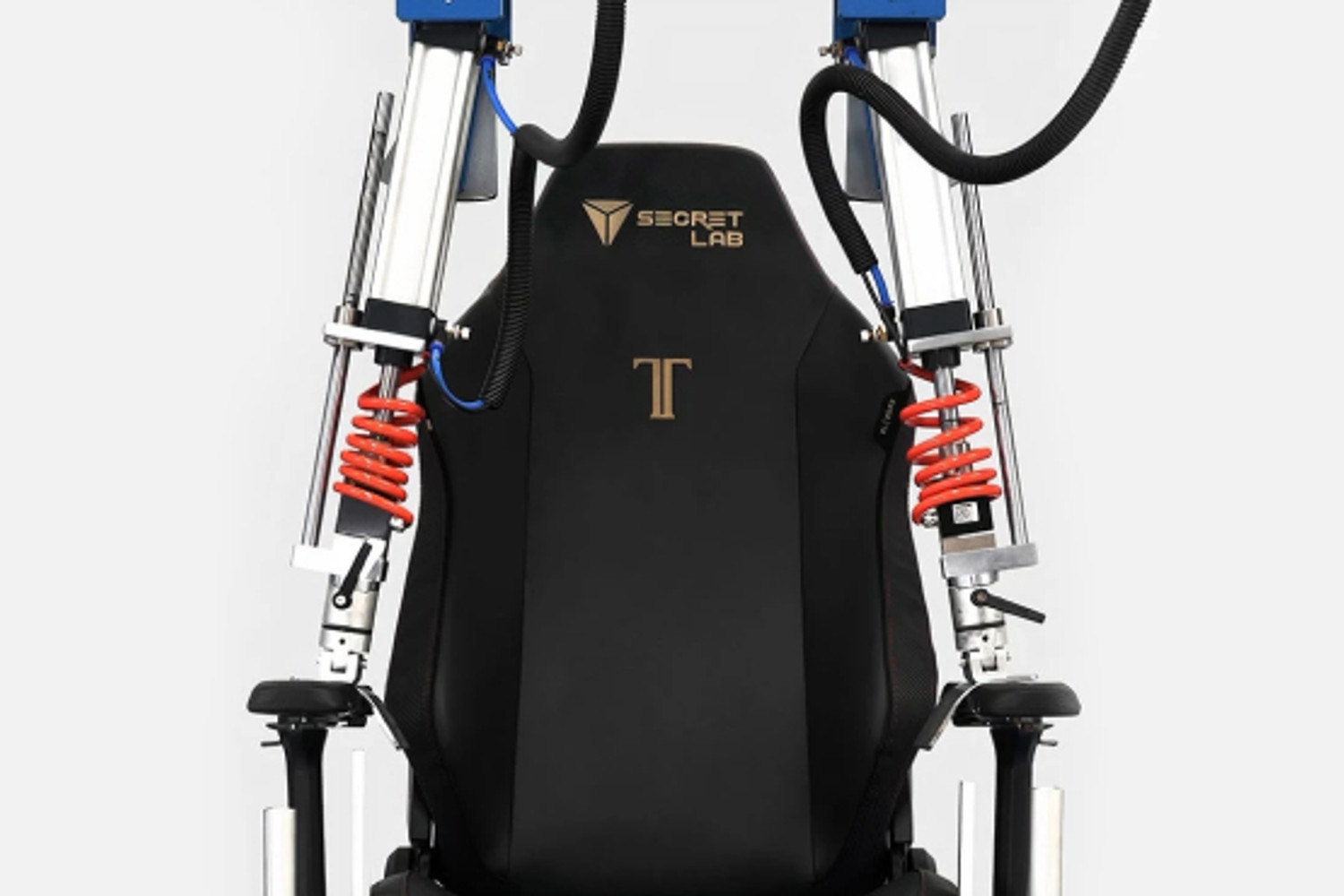 A black Secret Lab gaming chair equipped with mechanical attachments, including hydraulic springs and metal rods, positioned on the back and sides, possibly for a simulation or testing setup, displayed against a plain white background.