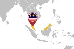 A map of Southeast Asia with the country of Malaysia highlighted in gold. A red location pin with the Malaysian flag (blue field with crescent and star, red and white stripes) marks the region of Malaysia. Surrounding countries are shown in gray.