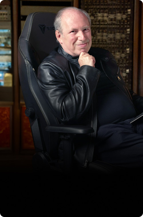 Hans Zimmer in his studio, sitting on on a Secretlab TITAN Evo Dark Knight Edition chair