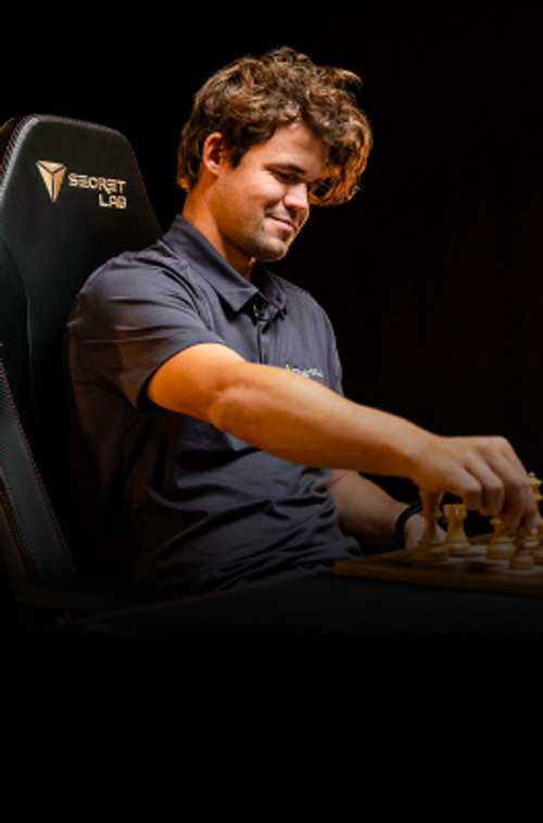 Magnus Carlsen playing chess on a Secretlab TITAN Evo chair