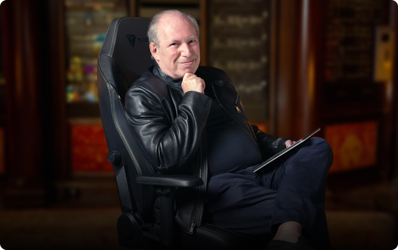 Hans Zimmer in his studio, sitting on on a Secretlab TITAN Evo Dark Knight Edition chair